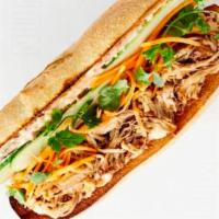 Pulled Duroc Pork Sandwich · Spiced honey. Served with cucumber, pickled carrots, cilantro and chili mayo on bread baked ...