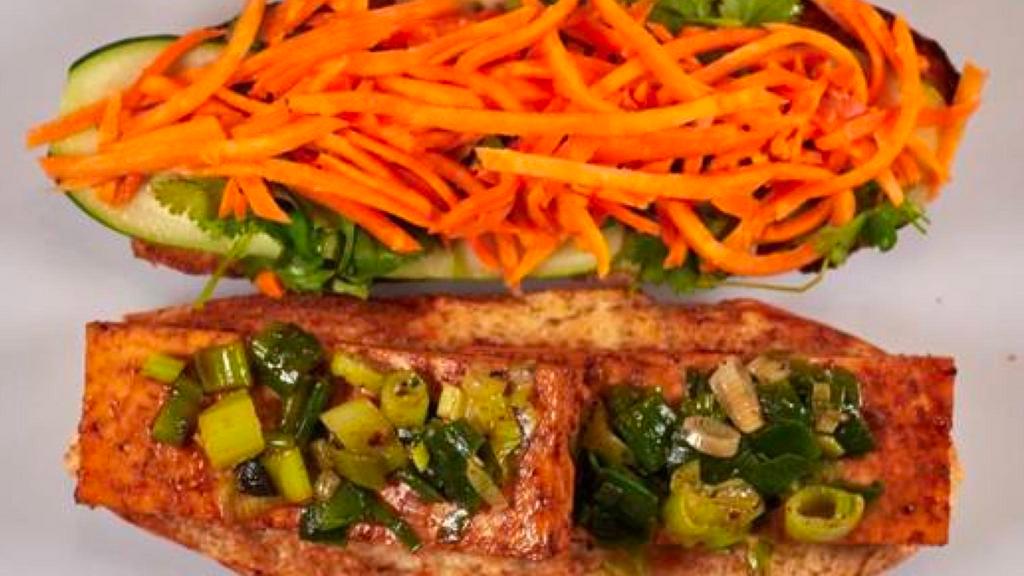 Spicy Organic Tofu Sandwich · Ginger soy-honey glaze and sautéed scallions, sweet soy ginger. Served with cucumber, pickled carrots, cilantro and chili mayo on bread baked fresh daily.