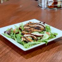 Black and Blue Salad · Mixed greens with tomatoes, cucumbers and red onions. Topped with blackened chicken and blue...