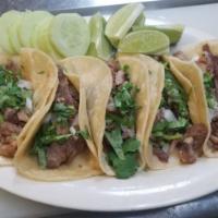 Taco de Carnitas · Fried pork in corn tortilla topped with chopped onions and cilantro