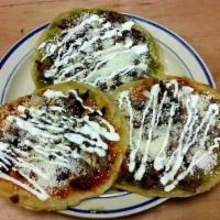 Picaditas con Carne · Lightly fried masa wheels topped with your choice of sauce and meat, onions, cotija cheese a...