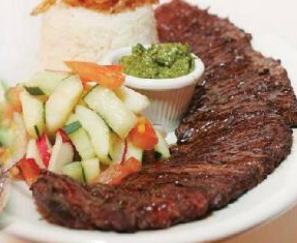 Skirt steak · Skirt  steak. Served with choice of side: rice and beans, plantain, sweet plantain, green salad or vegetables.