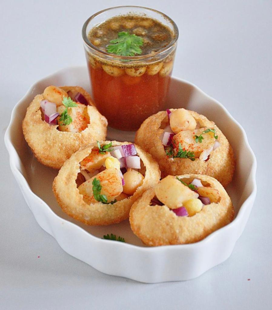 Gol Gappe/Pani Puri (7 pieces) · South Asian Street food compromising of spicy dipping water, a potato and chickpea filling and semolina shells. 