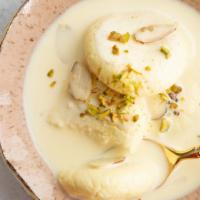 Rasmalai · 2 pieces. Clotted cream patties with cardamom served in sweet cold milk. 