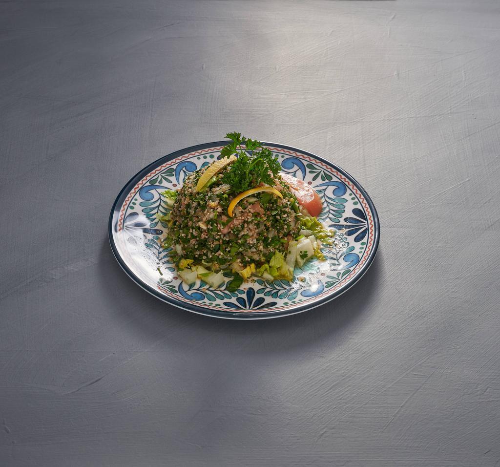 Tabouli Salad · Parsley, diced tomato, onion, cracked wheat (bulgur), olive oil and lemon juice.