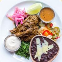 Yucatan Smoked Pork · Achiote rubbed pork, marinated in sour orange and roasted overnight in banana leaves. Served...