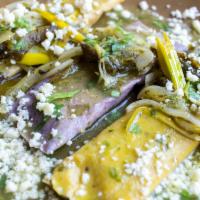 Tamales · Tamales steamed in banana leaf, 1 with Oaxaca black beans cooked with pasilla de Oaxaca chil...