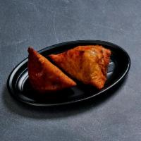 Vegetable Samosa · 2 pieces. Potatoes and peas stuffed in a savory pastry.