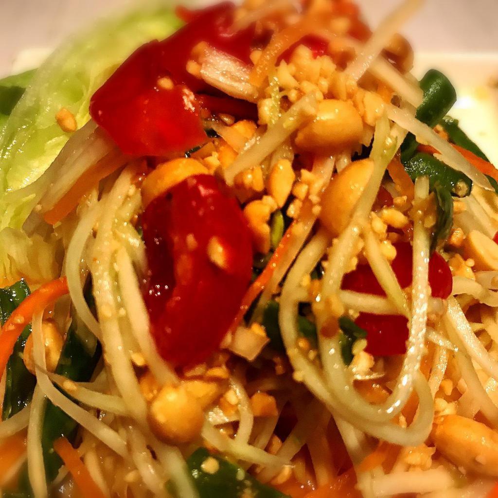 Som Tum  · Papaya salad. Julienne green papaya with tomato, carrot, peanut, chili, garlic and string beans with Thai style lime dressing. Gluten free.
