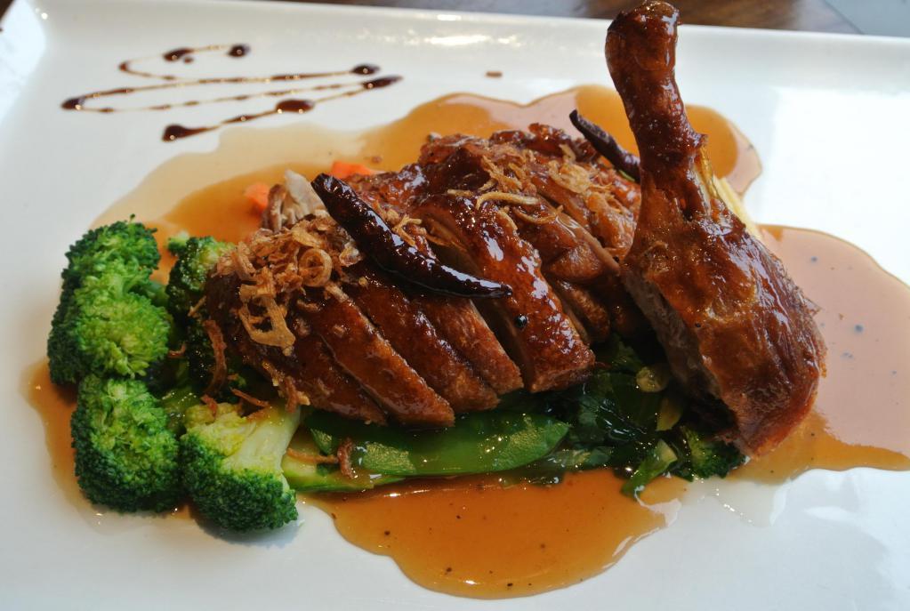 Tamarind Duck · Crispy Long Island duck with tamarind sauce on bed of steamed mixed vegetables.