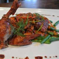 Chu Chee Duck · Crispy Long Island duck with chu chee curry sauce on bed of string beans and snow pea. Spicy.