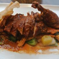 Thailand Duck · Crispy Long Island duck with basil, carrot, snow pea, bell pepper, tomato, and pineapple ser...