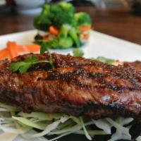 Enthaice Steak · 12 oz. grilled marinated Thai style NY sirloin steak served with chili and rice powder dippi...