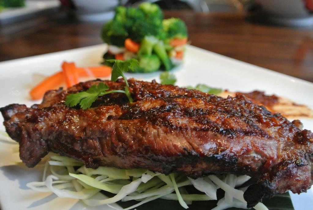 Enthaice Steak · 12 oz. grilled marinated Thai style NY sirloin steak served with chili and rice powder dipping sauce with sticky rice and mixed seasonal vegetables.