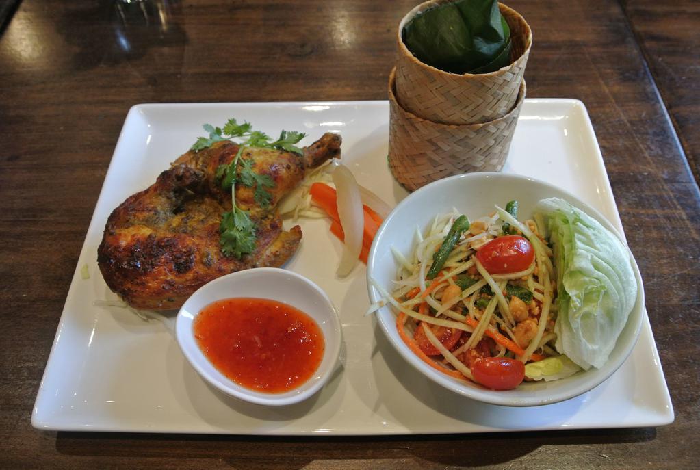 BBQ Chicken · Grilled half chicken with your choice of papaya salad or steamed mixed vegetables served with sticky and a side of sweet chili sauce,.