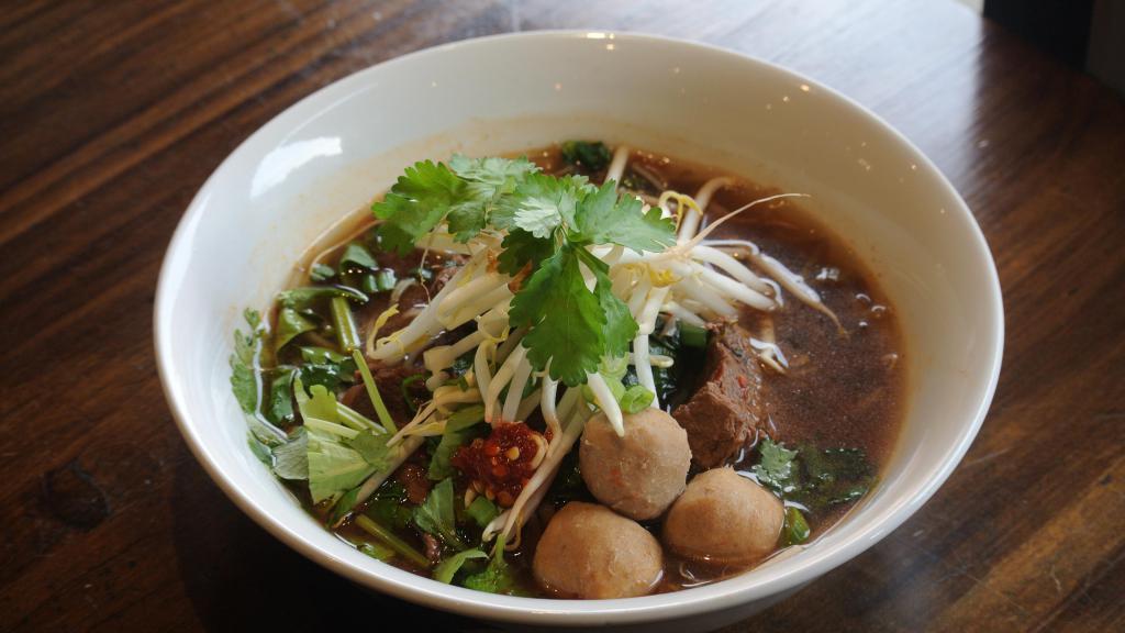 Thai Beef Stew · Strewed beef chunks and beef ball with rice noodle, basil, Chinese broccoli, beam sprout, scallion and garlic in spicy beef broth. Spicy.