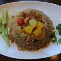 Pineapple Fried Rice · With pineapple, cashew nuts, onion, tomato, raisin, scallion, mixed peas and carrot and egg.