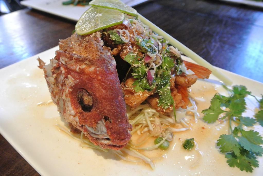Larb Pla Tod · Crispy whole red snapper with chilli powder, red onion, mint, cilantro, scallion, lemongrass lime leaf, roasted rice powder and spicy lime dressing.