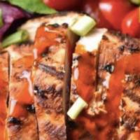 Buffalo Chicken Salad · Grilled chicken tossed in mild Buffalo sauce with celery and crumbly blue cheese on a field ...