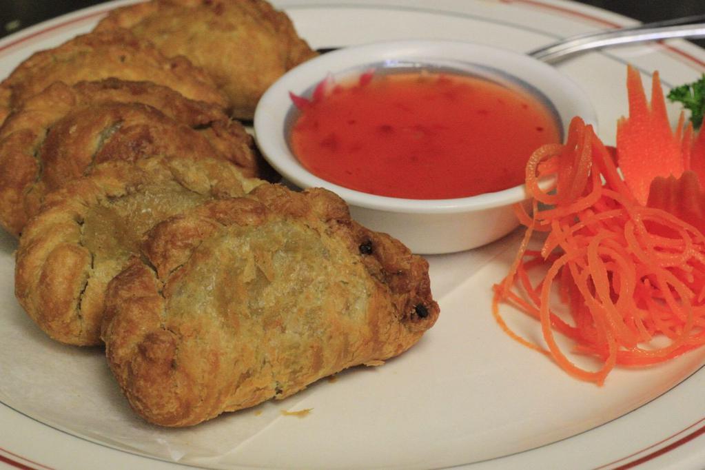 Curry Puff · Chicken, potatoes, celery, and onion, hand wrapped in pastry & crispy fried. Served with sweet chili sauce.