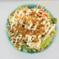 Shmulkys Salad · Mix lettuce and rice, corned beef, and schnitzel, cucumber, roasted peppers, green olives, p...