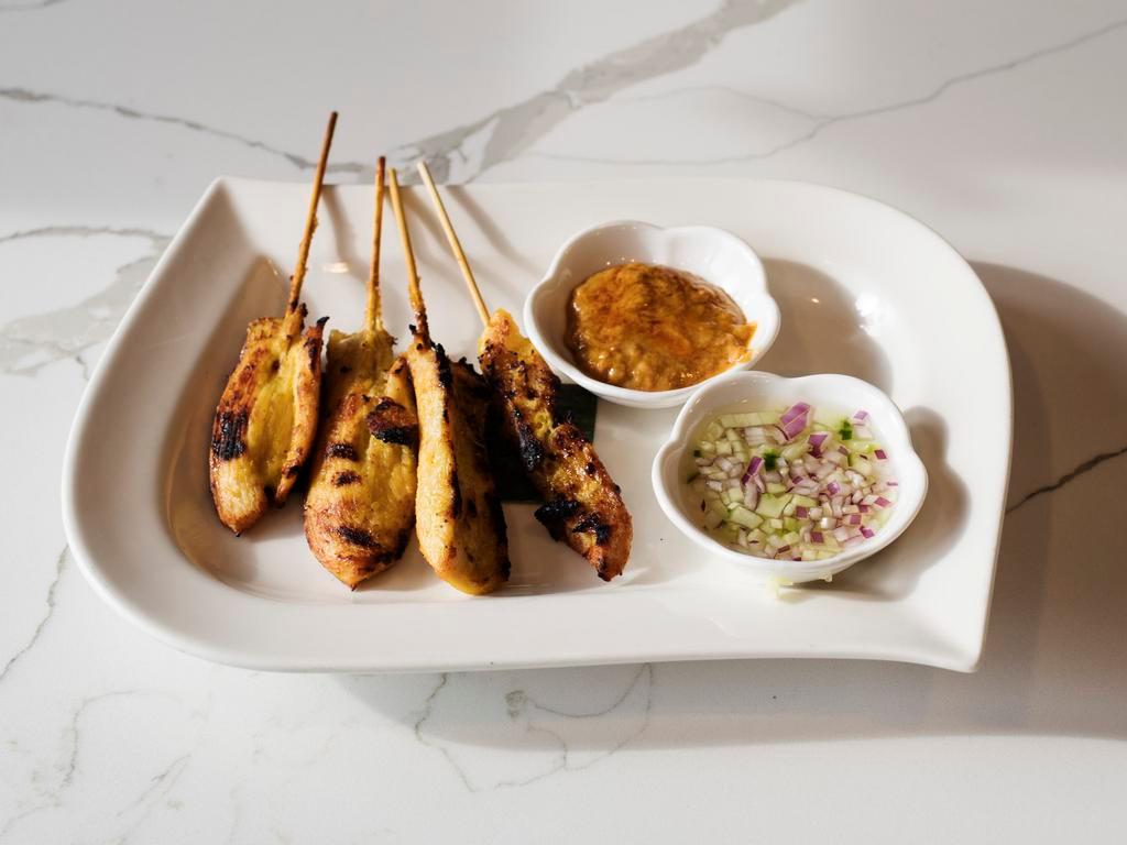 Chicken Satay · Marinated chicken on skewer served with peanut sauce and cucumber vinaigrette.