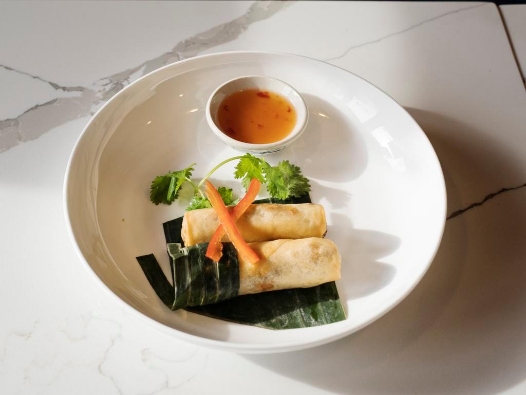 Po Pia Tod · Crispy roll stuffed with carrot, cabbage and taro folded in vermicelli served with plum vinaigrette dipping sauce.