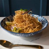 Kao Soi · Egg noodles and chicken thigh or vegetables simmered in curry soup, topped with crispy egg n...