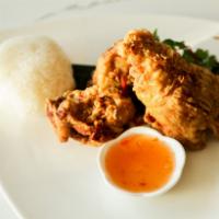 Had Yai Fried Chicken · Marinated with turmeric, garlic, cilantro root served with fried shallot and sweet chili sau...