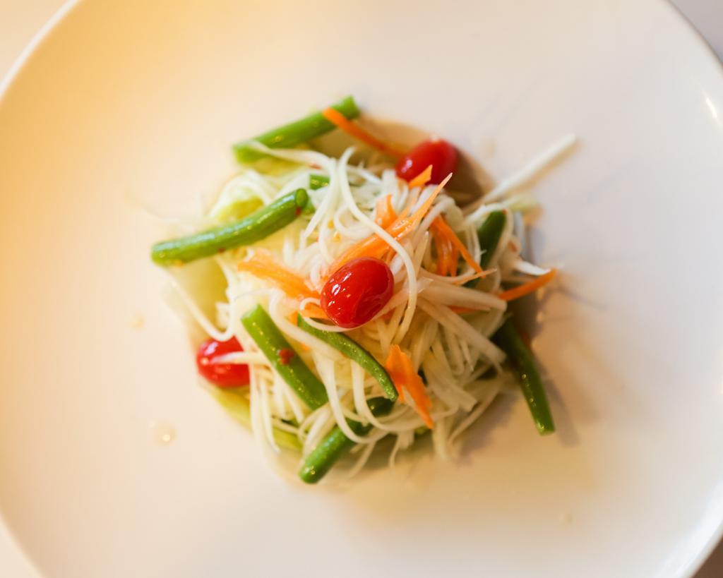 Papaya Salad · Shredded green papaya, tomato, string bean and peanut tossed in an exotic Thai spicy lime dressing.