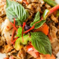 Pad Kee Mow · Sauteed wide noodles with egg, onion, tomato, hot pepper, and basil leaf in chili basil sauc...