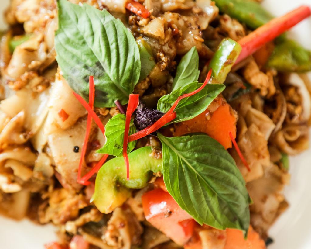 Pad Kee Mow · Sauteed wide noodles with egg, onion, tomato, hot pepper, and basil leaf in chili basil sauce. Spicy.