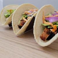 Chicken Suya Tacos · Thinly sliced slow grilled chicken marinated in Nigerian yaji (peanut spice) served with 3 c...