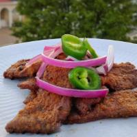 Steak Suya · Thinly sliced, grilled steak marinated in Nigerian yaji (peanut spice) served with sliced ca...