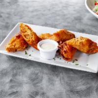 Buffalo Chicken Roll Ups · Crispy fried egg rolls stuffed with pulled chicken breast, cream cheese, bleu cheese, green ...