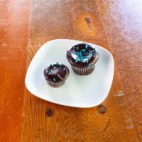 Chocolate with Hot Fudge Cupcake · Rich and fudgy chocolate cake dipped in velvety hot fudge.