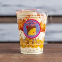 Corn in A Cup · Fresh corn drizzled in homemade corn crema and topped off with cotija cheese & chili powder.
