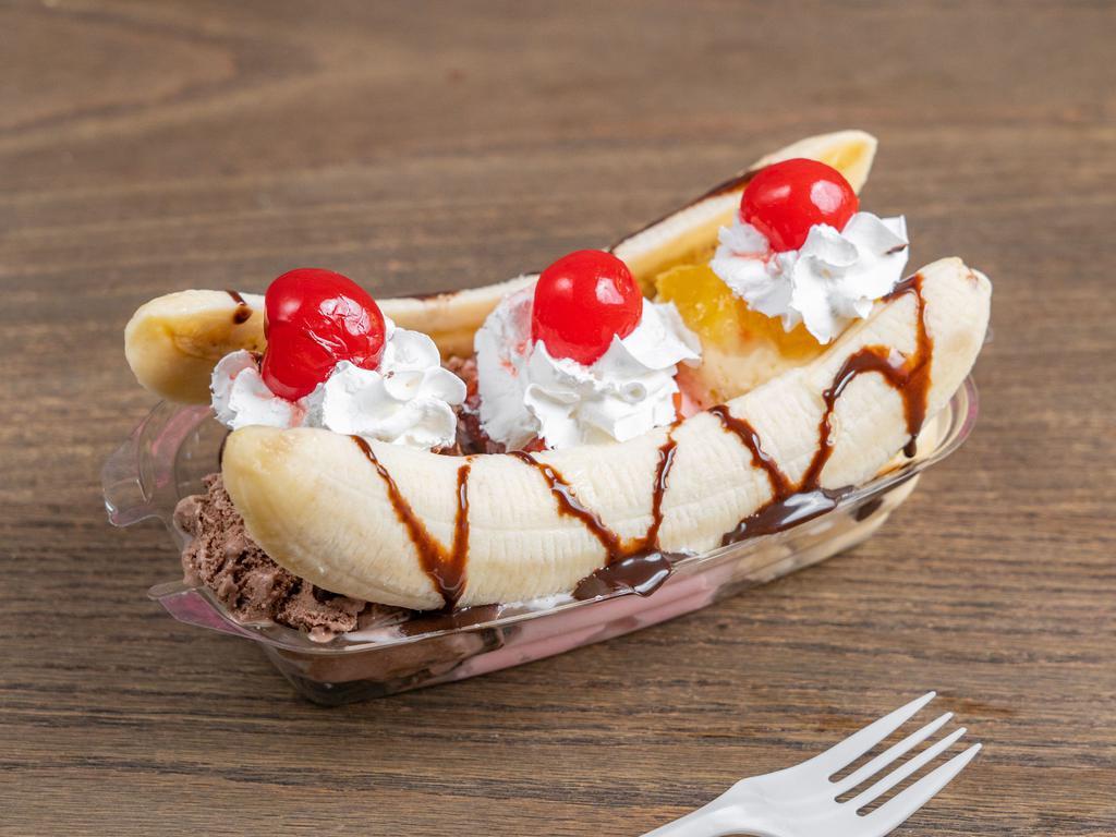 Banana Split · Strawberry, Chocolate, and vanilla ice cream, topped off with pineapple and strawberry jelly, as well as a chocolate syrup drizzle, whip cream, and cherries, all in between a freshly split banana!