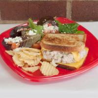 Tuna Melt Panini · Tuna salad with cheddar cheese and tomatoes. Served with chips and a pickle.