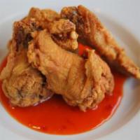 Chicken Wing · Fried chicken wing with spicy sauce.