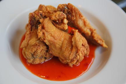 Chicken Wing · Fried chicken wing with spicy sauce.
