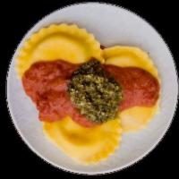 Ravioli Genovese · Ricotta cheese-filled pasta pillows topped with tomato sauce and a dollop of fresh basil pes...