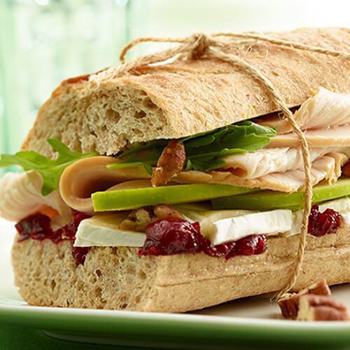 Turkey & Brie Nirvana · This sandwich has it all — fresh arugula, thinly-sliced  apples, lean turkey breast, Brie cheese and a savory cranberry souce. This Turkey & Brie Baguette is sandwich nirvana(Fresh roasted turkey, French brie, cranberry sauce and Granny Smith apples)
