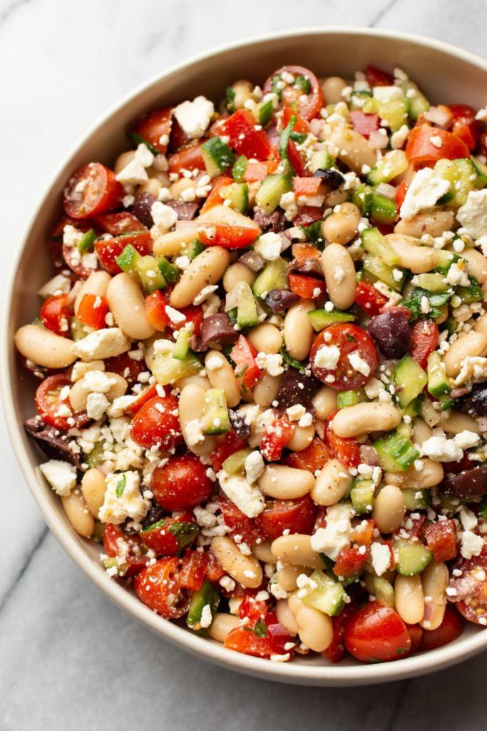 Freshly Made Mediterranean White Kidney Beans Salad · This  white bean salad recipe is healthy, simple to make, and packed with veggies and a light vinaigrette dressing. White kidney beans, parsley, red onion, red and yellow peppers, fresh cut steamed carrots, olive oil and lemon juice and salt.