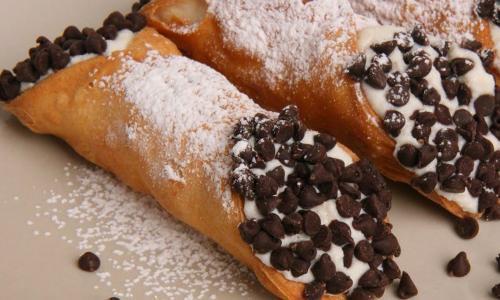 Fresh Handmade X-Large New Traditional Cannoli · Golden crispy shells filled with a signature recipe of ricotta cheese, hints of cinnamon & chocolate chips...