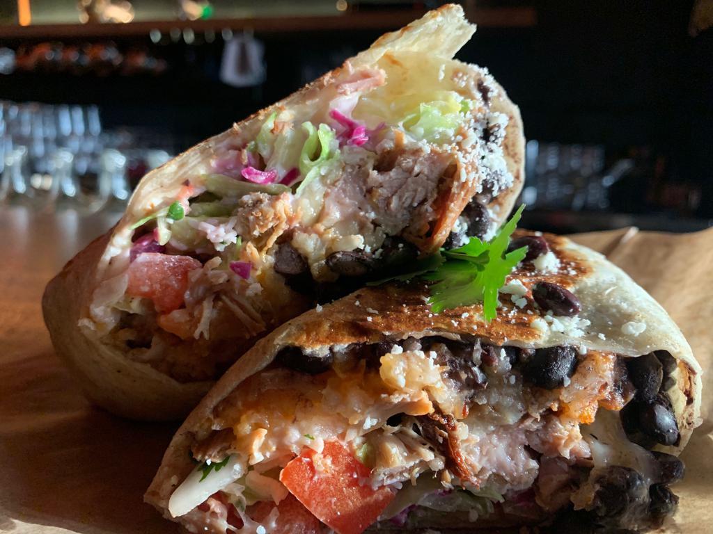 Buho Burrito · 12” tortilla, black beans, rice, Monterey Jack, pico, lettuce, cabbage and crema. Add egg for an additional charge. Add smother with queso sauce for an additional charge.