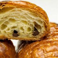 Chocolate Croissant · Buttery brioche dough, laminated with rich European butter, filled and dipped in Belgian dar...