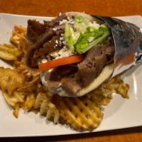 Gyro · Shaved lamb and beef topped with tomatoes, shredded lettuce, onions, tzatziki, fries, and fe...