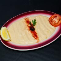 Hummus · Mashed chick peas blended with fresh garlic, tahini and herbs.