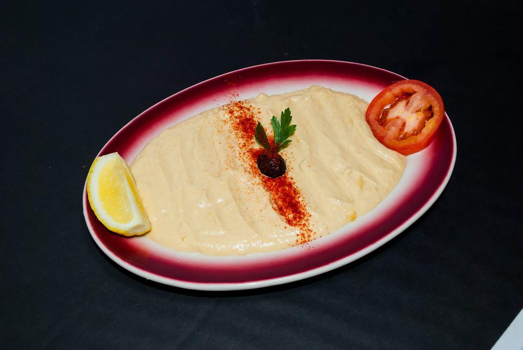 Hummus · Mashed chick peas blended with fresh garlic, tahini and herbs.